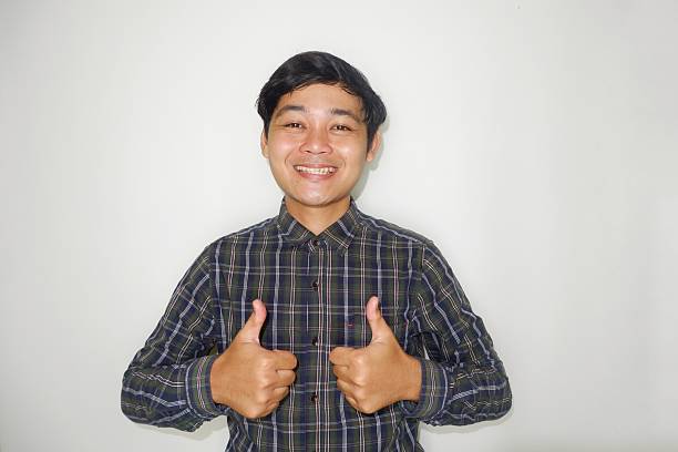 istock an Indonesian man is taking a selfie with a random expression and style and green shirt, self potrait 2203913323