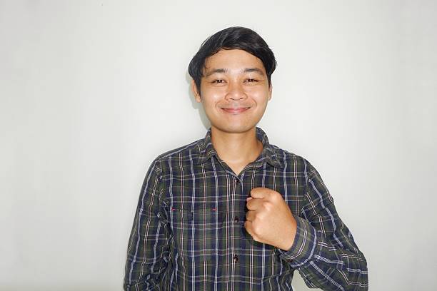 istock an Indonesian man is taking a selfie with a random expression and style and green shirt, self potrait 2203913546