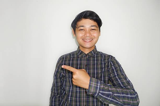 istock an Indonesian man is taking a selfie with a random expression and style and green shirt, self potrait 2203913553