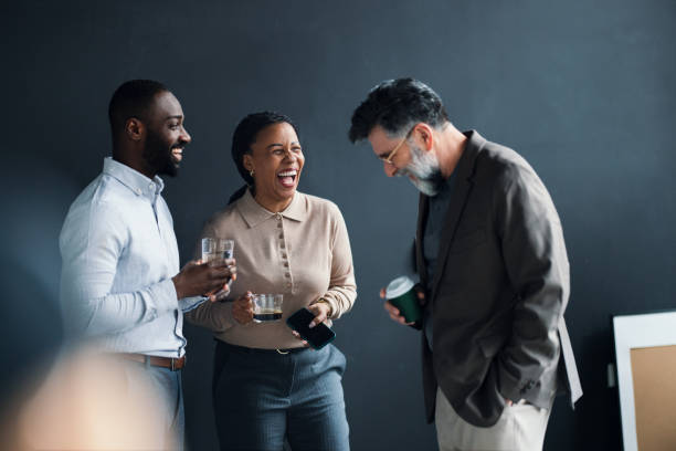 Business Professionals Enjoying Laughter During a Break in the Office
