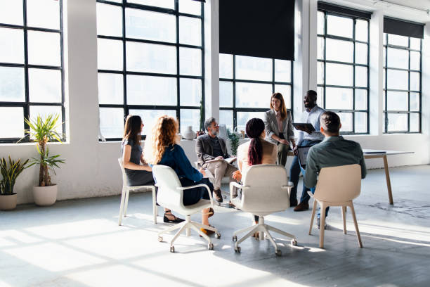 istock Team Meeting in Bright Modern Office Workspace with Diverse Business Professionals 2203913961
