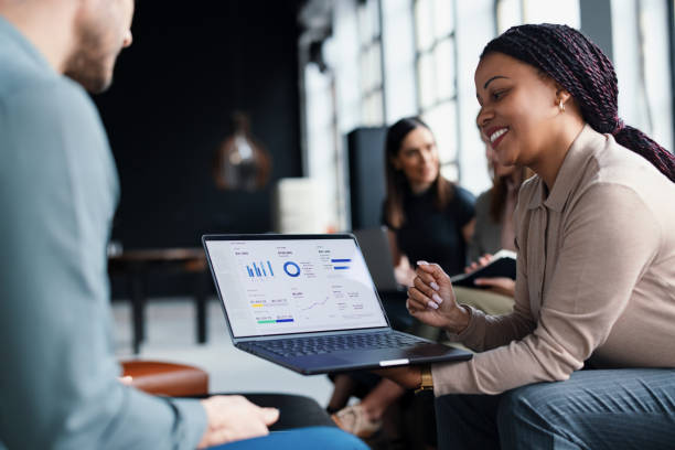 istock Business Colleagues Discussing Data and Charts on a Laptop Screen 2203913972