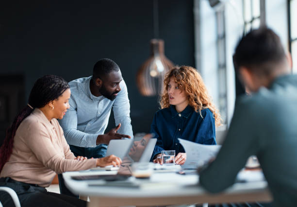 istock Focused Team Collaborating on a Business Project in Modern Office Environment 2203914025
