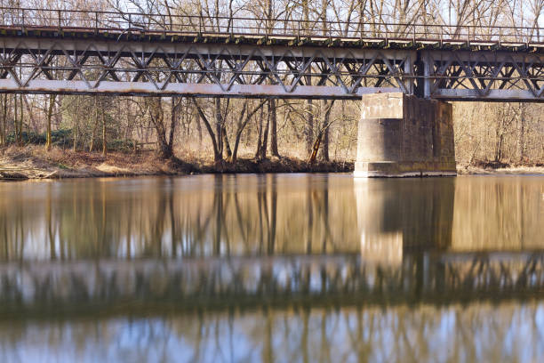 istock very old Iron bridge over a River in sunlight - Industrial architecture over 100 years old 2203915737