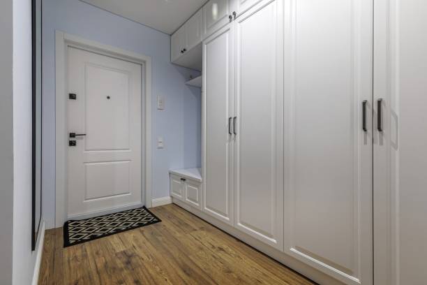 istock Stylish Hallway with White Storage and Wooden Flooring 2203916337