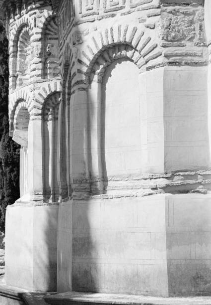 Detail of Greek Island Monastery Captured on Black and White Analog Film Detail of the Nea Moni monastery on the Greek Island of Chios captured on old-fashioned analog (or analogue) grainy (ISO 400) black and white film. The Nea Moni (New Monastery) is situated on the mountain of Provateio Oros on the Greek Island of Chios in the Aegean Sea, 15 km from Chios Town (Hora). It is on the UNESCO World Heritage List. It was built in the mid-11th century by the Byzantine emperor Constantine IX on the spot where legend holds that three monks fond an icon of the Virgin Mary. At its peak around 1300, 800 monks and one third of the land of Chios belonged to the monastery. Buildings and inventory suffered after the Turkish massacre in 1822 and a massive earthquake in 1881 marking the decline of the monastery. The image is part of a series of black and white analogue film images of Chios. black and white travel travel destinations monk stock pictures, royalty-free photos & images