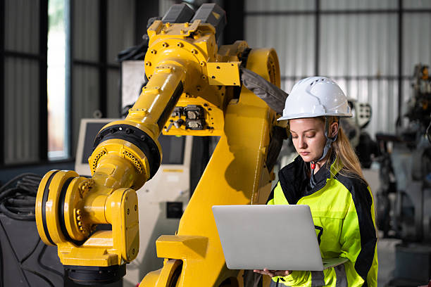 istock Engineer Caucasian woman use notebook computer checking arm robot in factory background 2203916756