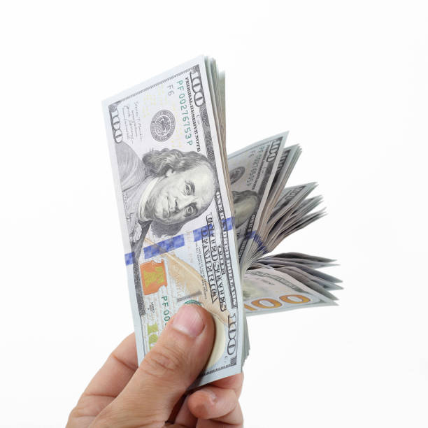 istock A man hand holds a stack of US hundred dollar bills 2203919179