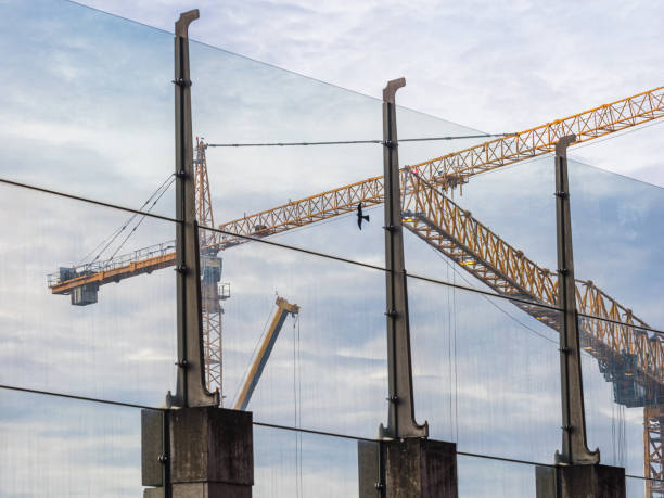istock Building cranes reflected in glass structures, showcasing construction activity in Gothenburg's skyline 2203920571