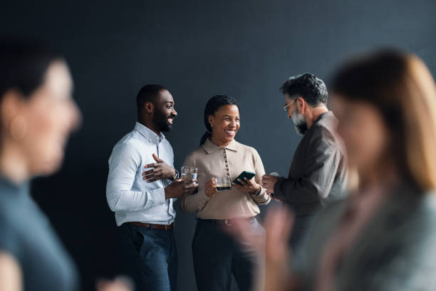 Group of Professionals Engaging in Conversation During Office Break