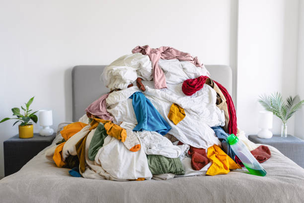 istock Pile of Unsorted Laundry on a Bed 2203924312