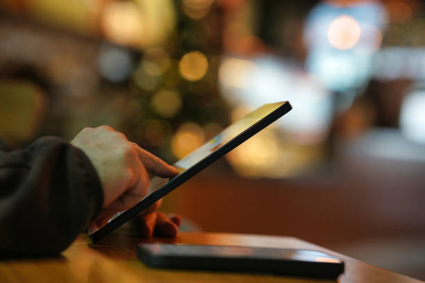 istock Person Using a Tablet with a Smartphone Nearby 2203925858