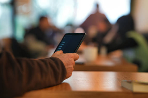 istock Person Browsing on a Tablet in a Public Space 2203926958