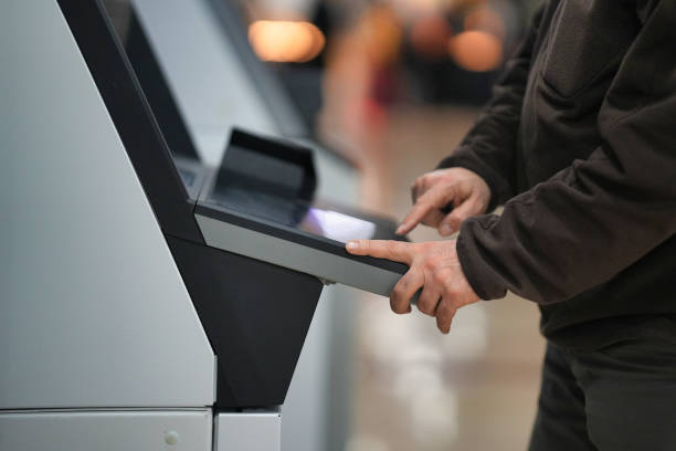 istock Person Using an ATM Touchscreen for Banking Transactions 2203928364