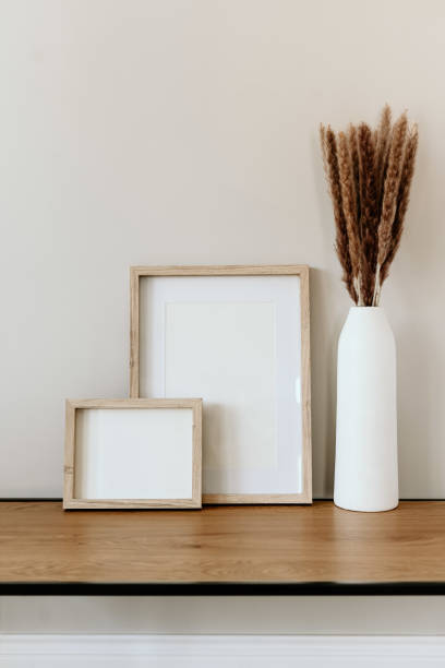 istock Minimalist decor with wooden frames and vase on console coffee table 2203932212