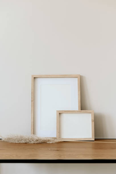 istock Minimalist decor with wooden frames and vase on console coffee table 2203932219
