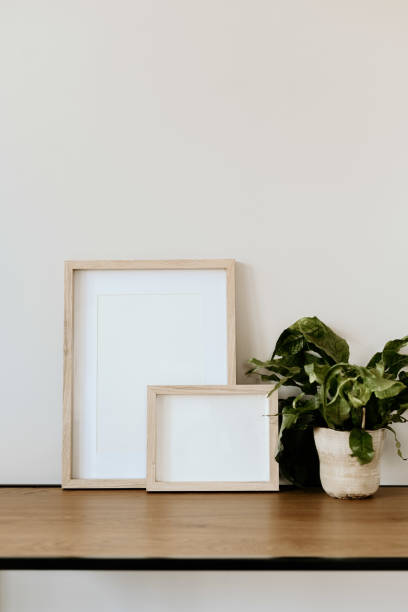 istock Minimalist decor with wooden frames and vase on console coffee table 2203932221