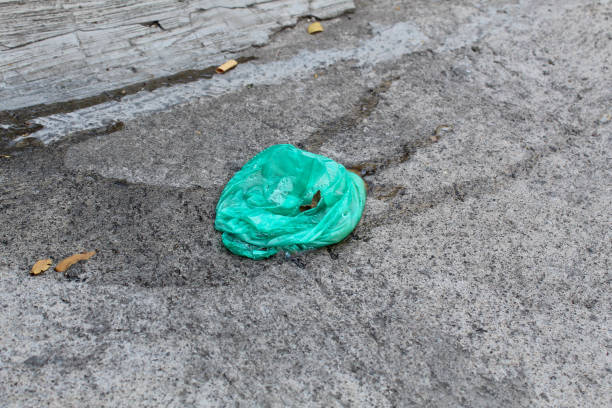 istock A wet green plastic trash on the cement floor 2203932556