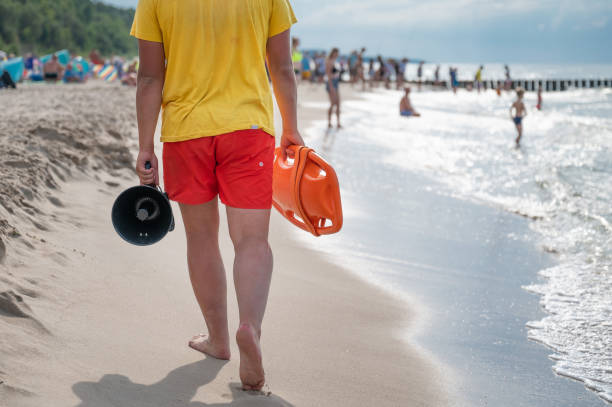 istock A lifeguard with a buoy patrols the beach 2203933497