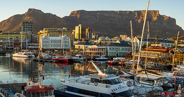 The iconic V&A Waterfront lit up beautifully at dawn with Table Mountain as a background - Cape Town, South Africa