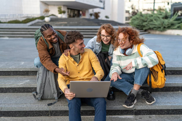 istock Multiethnic group of university students preparing for seminar while sitting together on stairs 2203934524