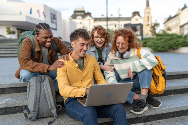 istock Multiethnic group of university students preparing for seminar while sitting together on stairs 2203934571