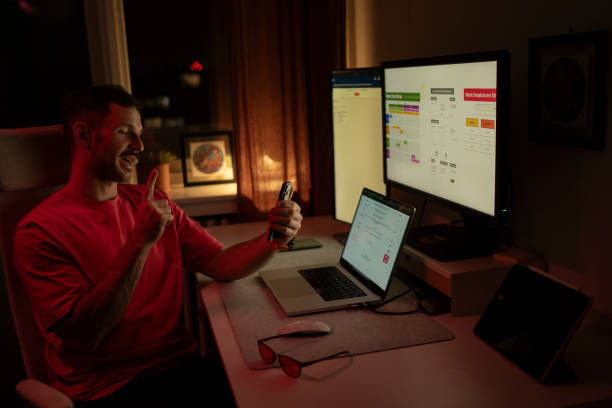 istock Young man working from home having a video call and pointing finger up 2203934612