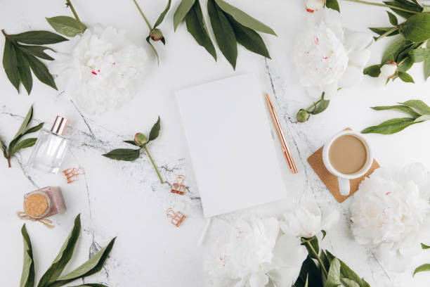 istock Women's marble table, diary mockup white peonies and coffee around, flat lay 2203935845