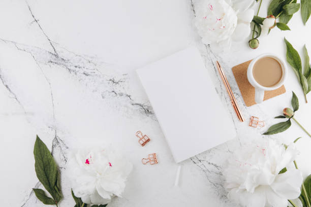 istock Women's marble table, diary mockup white peonies and coffee around, flat lay 2203935853