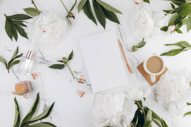 istock Women's marble table, diary mockup white peonies and coffee around, flat lay 2203936064