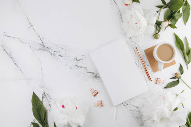 istock Women's marble table, diary mockup white peonies and coffee around, flat lay 2203936069