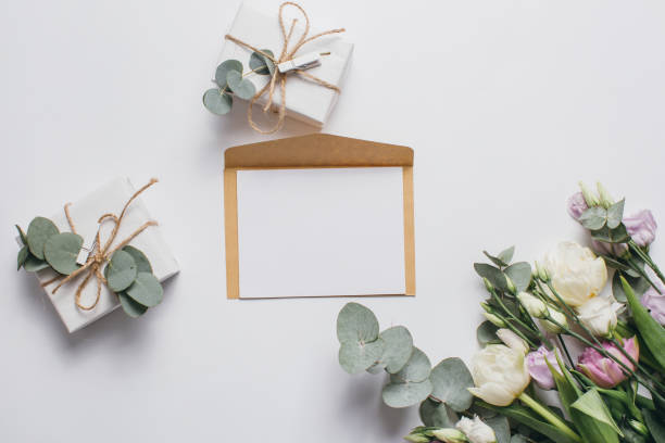 istock Mother's Day Composition: Eustoma, Eucalyptus, letter and a gift box on a white background. Top view.Flat lay. 2203940722