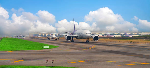 istock Queue of airliners before take off and exit to the runway at a busy major airport panoramic view. 2203941422