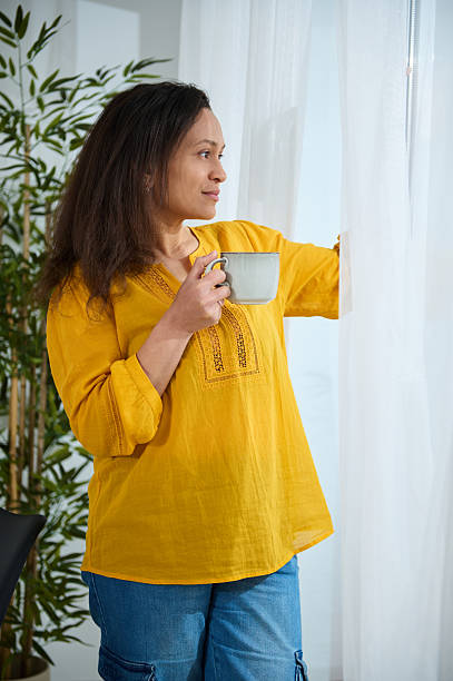 istock Casual Entrepreneur Relaxing While Sipping Coffee at Home Office Window 2203942843