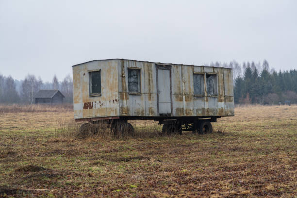 Old derelict caravan amongst junk on roadside