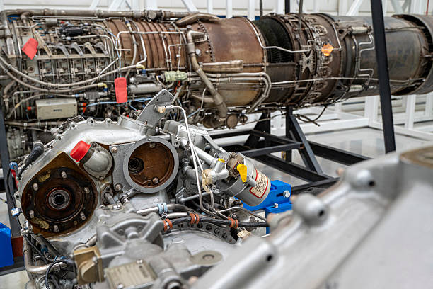 istock A large engine is sitting in a hangar with other engines. 2203948418