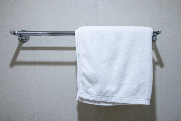 istock Clean white towels hanging on a rail in the bathroom. 2203950345