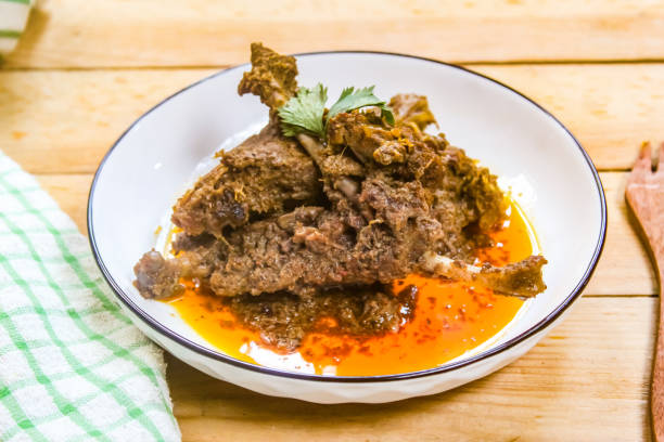 istock duck meat dish on a plate, cooked in a traditional way using spices and coconut. 2203950547
