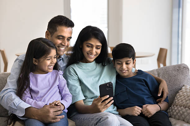 istock Family spend time watching videos online educational content on cellphone 2203951384