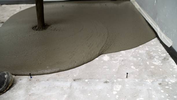 istock Construction workers pouring concrete mix on the floor 2203951472