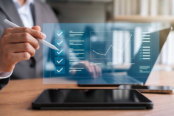 istock Electronic smart checklist, businessman using laptop and tablet checking business work documents, evaluating check mark on survey list in online form, digital document, paperless office. 2203952163