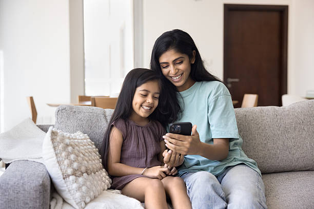 istock Indian mother spend time with little 5s daughter using smartphone 2203953729