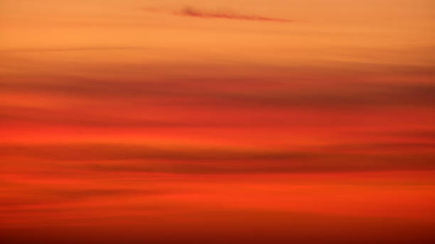 istock Blurred sunset sky with orange and red gradient clouds. Nature background for design and print 2203958553