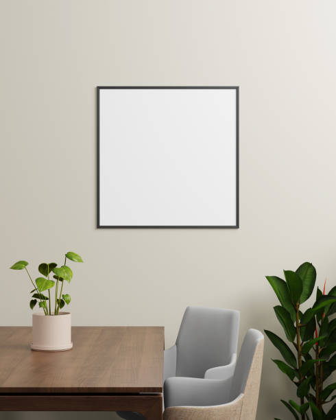 istock A black square photo frame on a light wall, with plants and a wooden table, ideal for showcasing smaller artwork or photographs in a modern setting. 2203961834