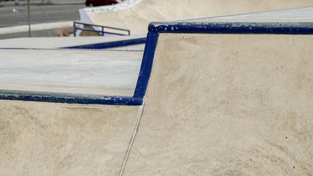 istock In an urban skate park, a concrete ramp with vibrant blue edges creates an inviting surface for skateboarders 2203962676