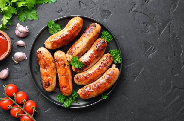 istock Roasted sausages on plate, top view 2203962721