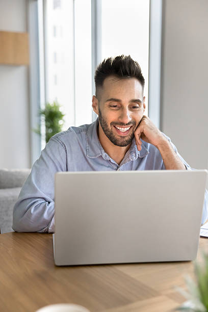 istock Man watches amusing content or read online news on laptop 2203963113