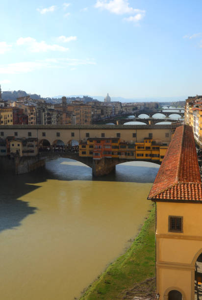 istock Old Bridge called ponte vecchio in florence in central italy with the covered walkway called the vasari corridor on the right and arno river 2203963995