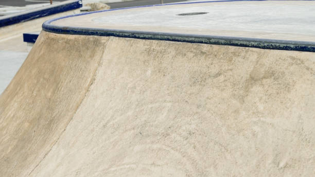 istock In an urban skate park, a concrete ramp with vibrant blue edges creates an inviting surface for skateboarders 2203964292