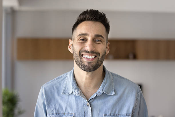 istock Head shot portrait young Hispanic man smile staring at camera 2203964577